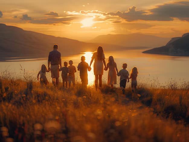 family with childrens walking hand hand grassy hill overlooking lake